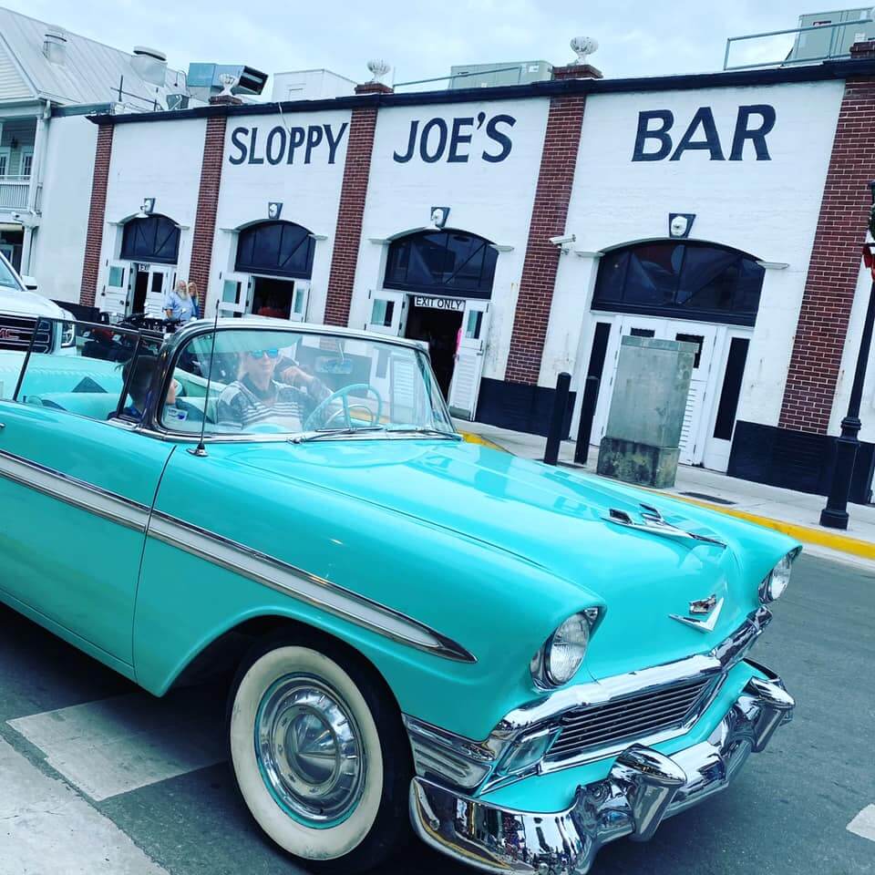 Classic Car cruising down Duval Street outside of the Famous Sloppy Joe's Bar in Key West Florida